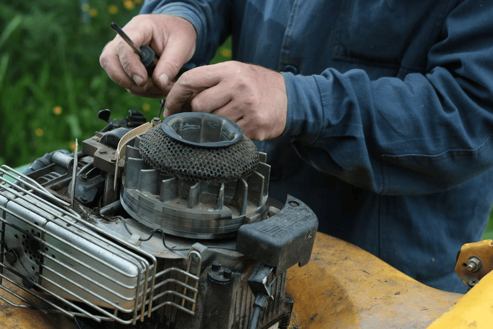 Man Repairing Lawn Mower Engine